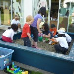 All the children playing in sand for the first time