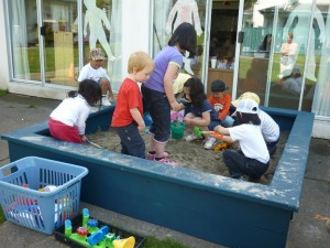 All the children playing in sand for the first time