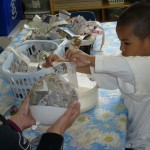 Covering the balloon in layers of paper mache